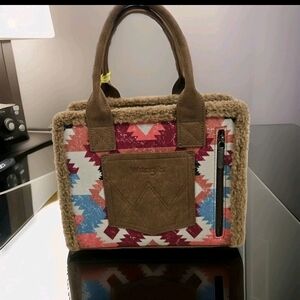 The Wrangler Southwestern Aztec Print Canvas Tote Crossbody Bag is a stylish and